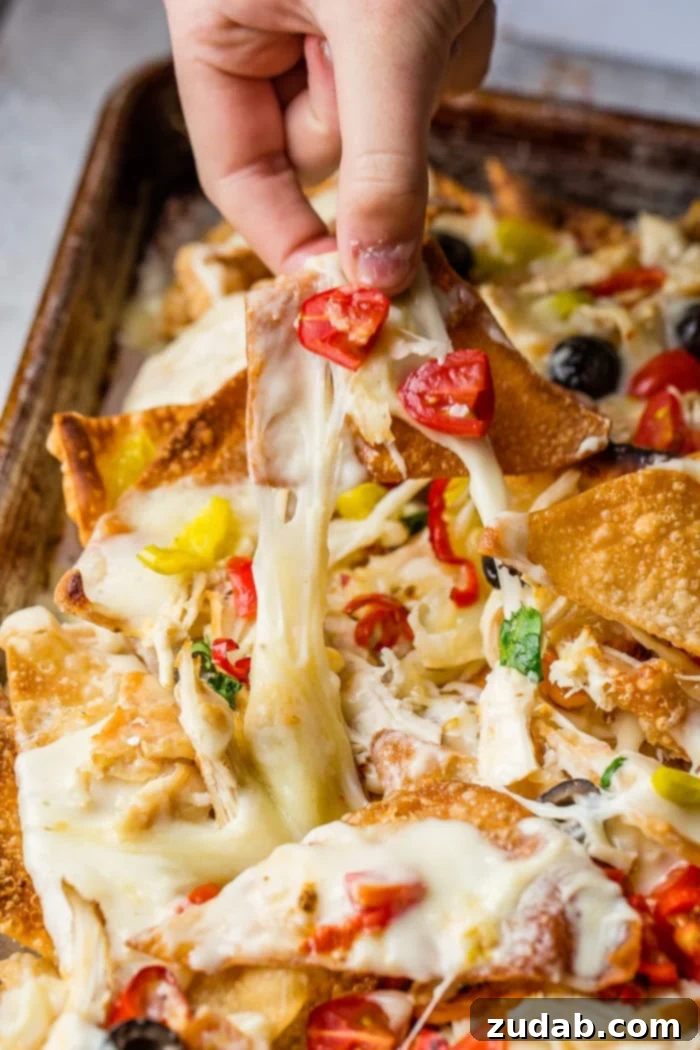 How to Make Italian Nachos 3 Fried wontons covered in alfredo sauce, cheese, chicken, peppers and olives for the perfect Italian Nachos