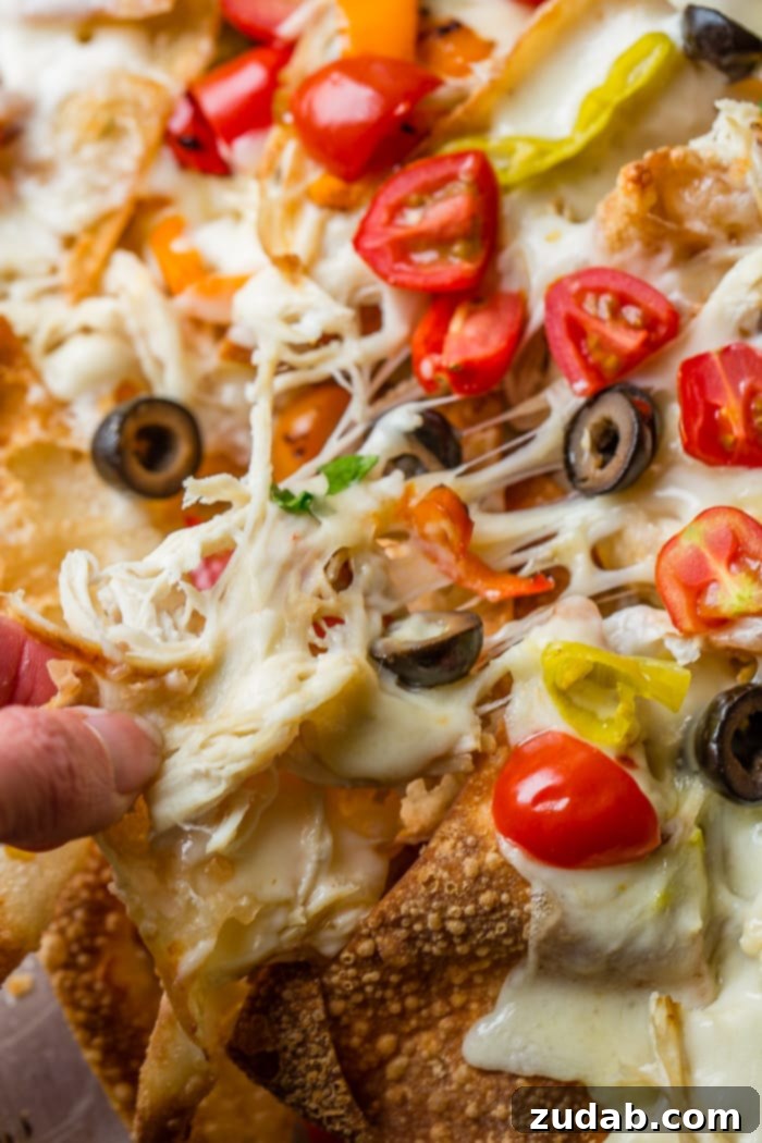 How to Make Italian Nachos 4 Fried wontons covered in alfredo sauce, cheese, chicken, peppers and olives for the perfect Italian Nachos