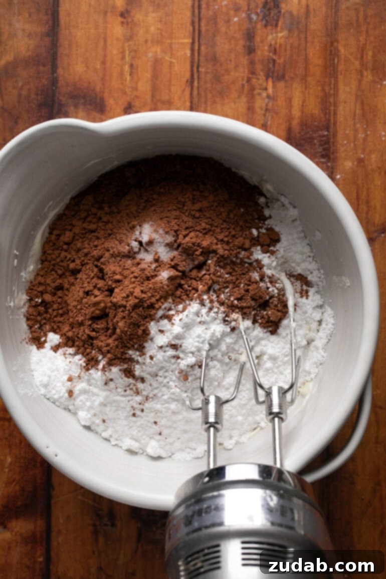 Gooey Chocolate Marshmallow Bites 16 Adding powdered sugar and cocoa to frosting