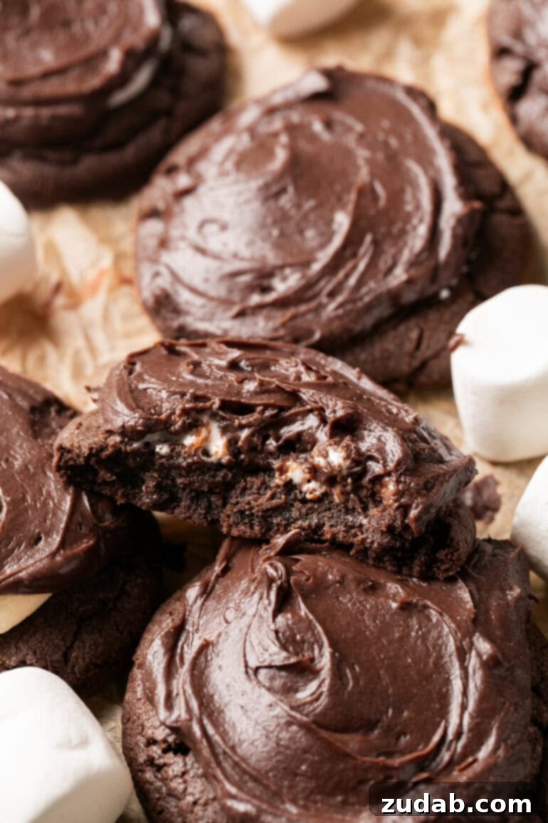 Gooey Chocolate Marshmallow Bites 3 a photo of a thick chocolate marshmallow cookie with a bite taken out of it so you can see the middle of the cookie