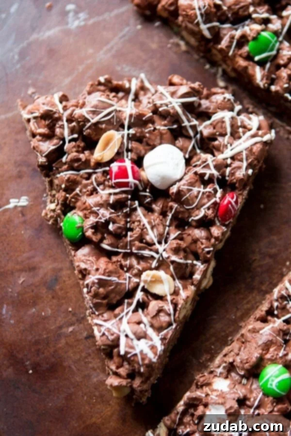 Homemade M&M Chocolate Pizza for Christmas Close-up of a vibrant M&M Chocolate Pizza slice, featuring colorful candies and rich chocolate.