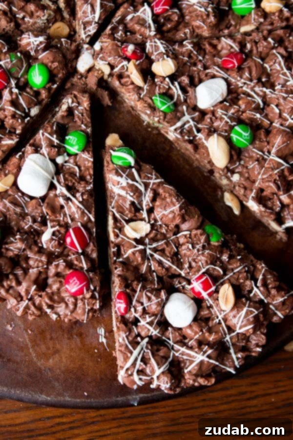 Easy No-Bake M&M Chocolate Pizza Recipe A cheerful M&M Chocolate Pizza, cut into slices, showcasing its delightful toppings and texture.