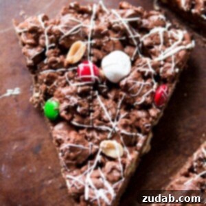 Delightful M&M Chocolate Pizza 4 M&M Chocolate Pizza displayed on a white background, highlighting its colorful candy toppings.