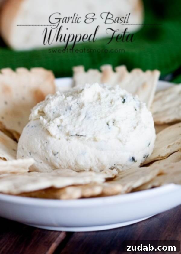 Garlic Basil Whipped Feta Dip - Fresh Appetizer Idea A vibrant bowl of Basil Whipped Feta Dip, garnished with fresh basil leaves and a drizzle of olive oil, accompanied by crusty bread for dipping. A fresh and flavorful appetizer.
