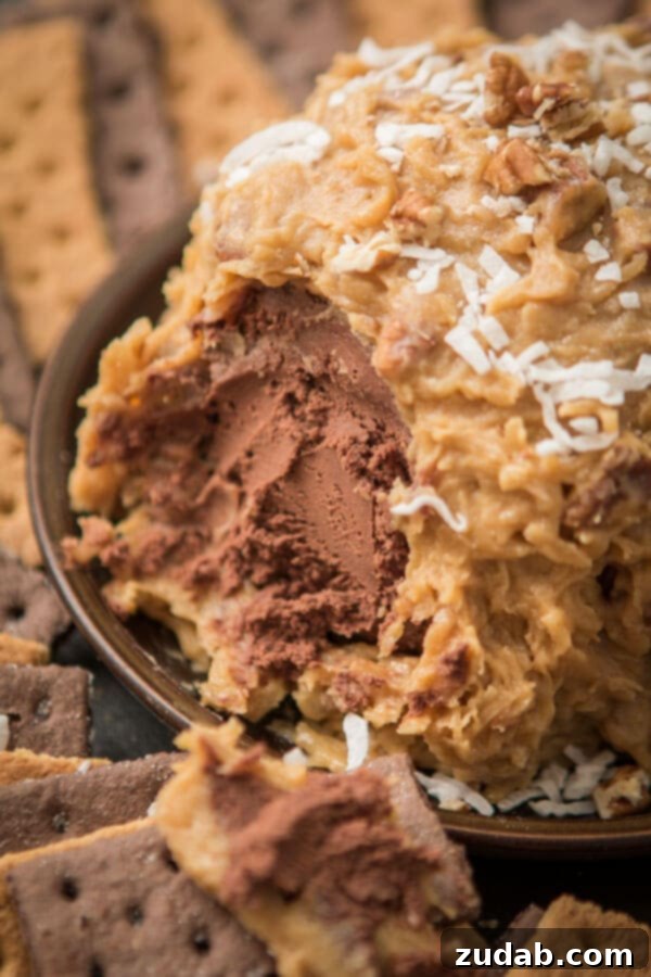 Love German chocolate cake? Especially that sticky coconut frosting? This German Chocolate Cake Cheese Ball is way easier than cake but just as delicious! A delicious German Chocolate Cake Cheese Ball, a sweet and sticky coconut frosting dessert, easier than baking a whole cake. ohsweetbasil.com