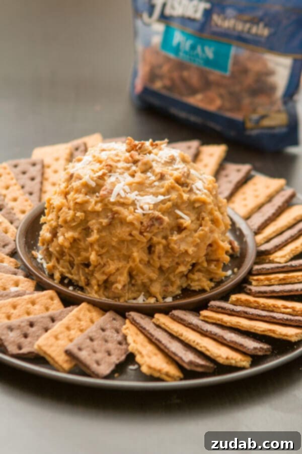 Love German chocolate cake? Especially that sticky coconut frosting? This German Chocolate Cake Cheese Ball is way easier than cake but just as delicious! The smooth, rich chocolate base of our German Chocolate Cake Cheese Ball, ready for its signature sticky coconut pecan frosting. ohsweetbasil.com