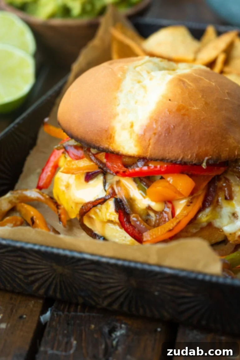 A close-up of a generously topped fajita burger, with melted cheese dripping down, creamy sauce, and a colorful array of sautéed peppers and onions, highlighting its irresistible appeal.