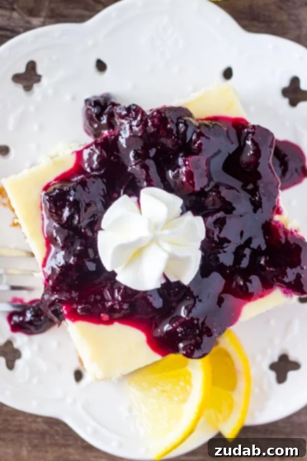 Lemon blueberry cheesecake squares are smooth & creamy with a delicious lemon flavor and crunchy graham cracker crust. The blueberry sauce makes them extra special!