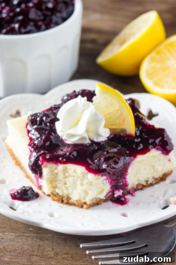 Lemon blueberry cheesecake squares are smooth & creamy with a delicious lemon flavor and crunchy graham cracker crust. The blueberry sauce makes them extra special!