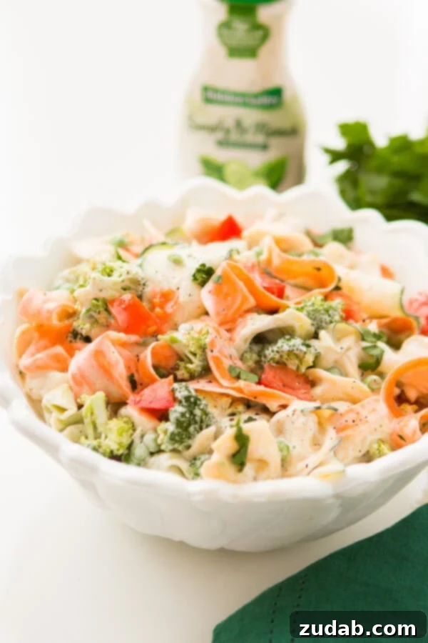 Easy Ranch Tortellini Pasta Salad for Potlucks A close-up of the delicious 10-minute ranch tortellini pasta salad, showcasing the fresh tortellini, vibrant vegetable ribbons, and creamy ranch dressing. An ideal side for any BBQ.