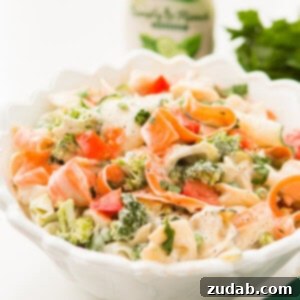 Easy 10-Minute Ranch Tortellini Pasta Salad 2 A vibrant bowl of 10-minute ranch tortellini pasta salad, garnished with fresh herbs. Perfect for any gathering.