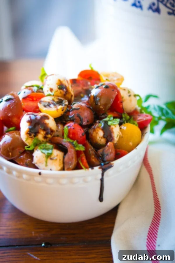 Reducing Balsamic Vinegar for a Rich Glaze A close-up of balsamic vinegar reducing in a non-stick skillet on the stovetop, transforming into a thick, glossy balsamic glaze, a key ingredient for an easy tomato mozzarella salad.