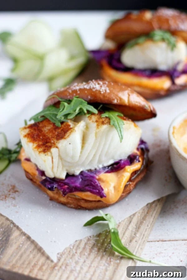 Blackened Fish Burger with Sriracha Mayo: A Quick and Healthy Dinner A perfectly blackened sea bass fillet served on a brioche bun with sriracha mayo and purple cabbage, ready in 30 minutes.
