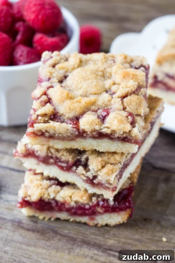 Easy Raspberry Crumble Bar Preparation Mixing ingredients for the shortbread base and crumble topping of raspberry bars.