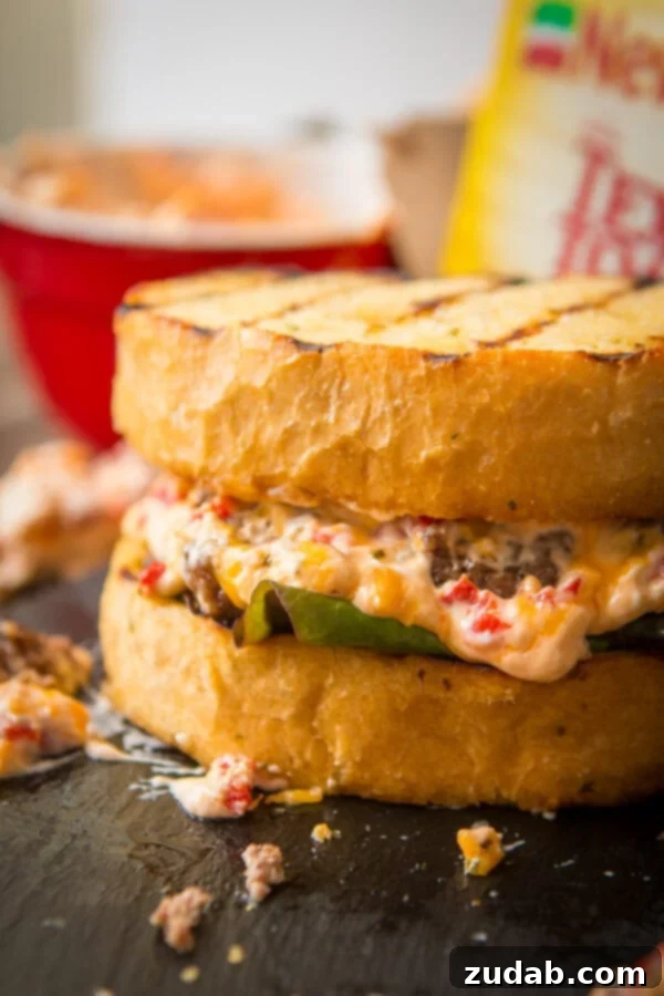 A delicious Southern Pimento Cheeseburger on Texas Toast, ready to be enjoyed. The best burger of the summer!