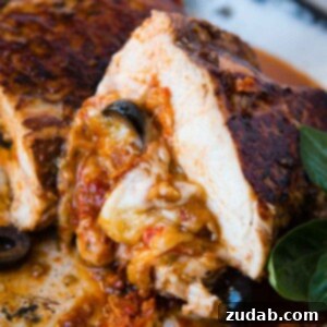 Gooey Cheese Stuffed Mediterranean Chicken 2 Close-up of a perfectly cooked Cheesy Stuffed Mediterranean Chicken, golden brown and ready to serve, featuring sun-dried tomatoes, olives, and mozzarella.