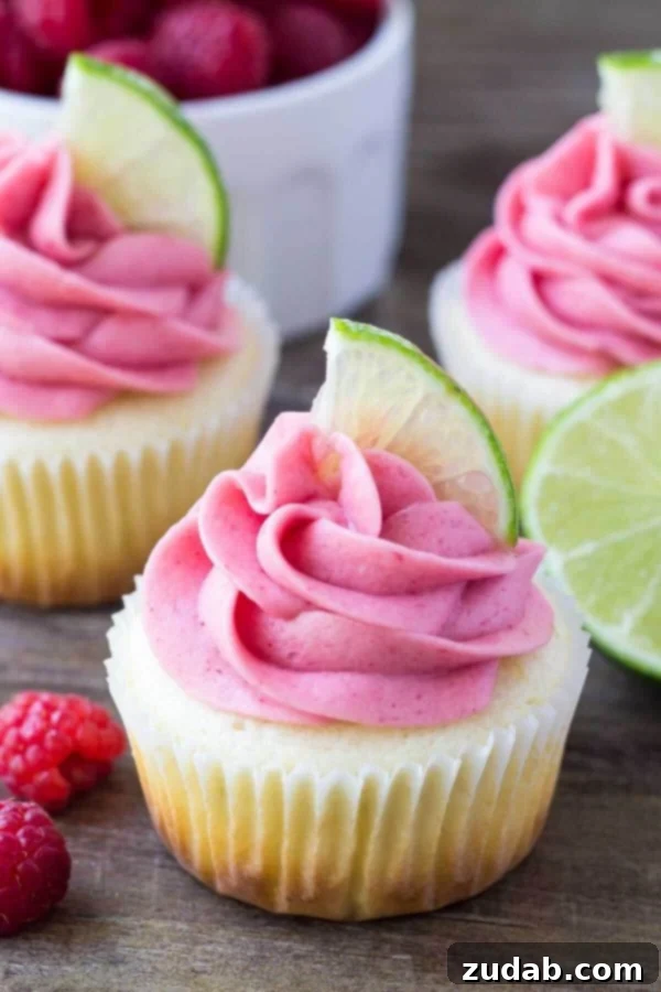 Delicious Raspberry Lime Cupcakes arranged neatly on a serving platter. A tray of fresh, homemade Raspberry Lime Cupcakes, ready for enjoyment.