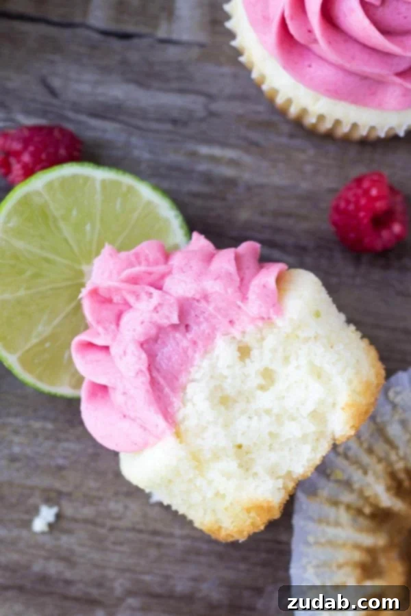 An array of Raspberry Lime Cupcakes, showcasing their delicate presentation. More perfectly frosted Raspberry Lime Cupcakes arranged artistically.