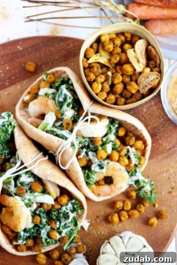 Assembling Your Healthy Pita Dinner A vibrant and healthy roasted chickpea and garlic Caesar salad pita being assembled.