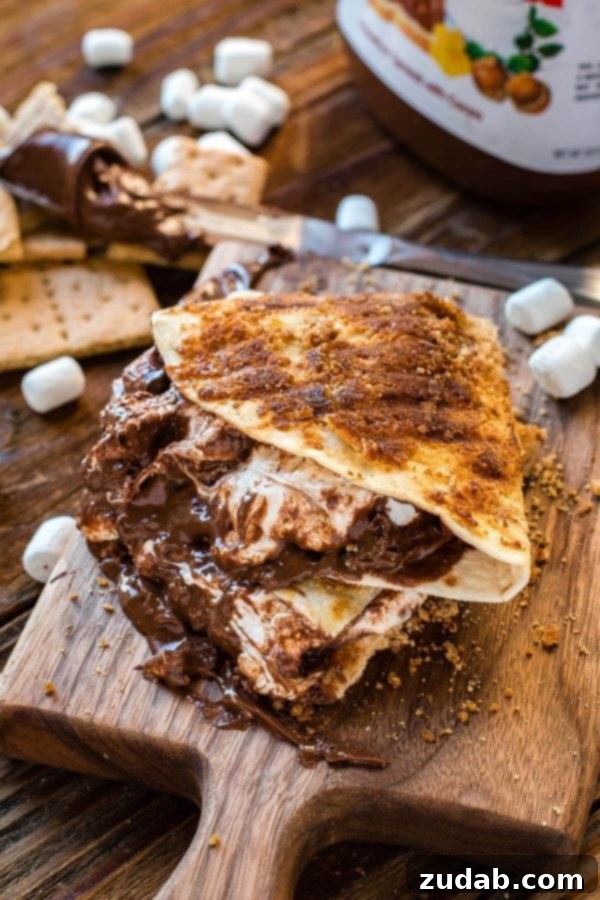 A stack of golden-brown grilled s'mores dessert quesadillas, ready to be enjoyed as a summer treat.