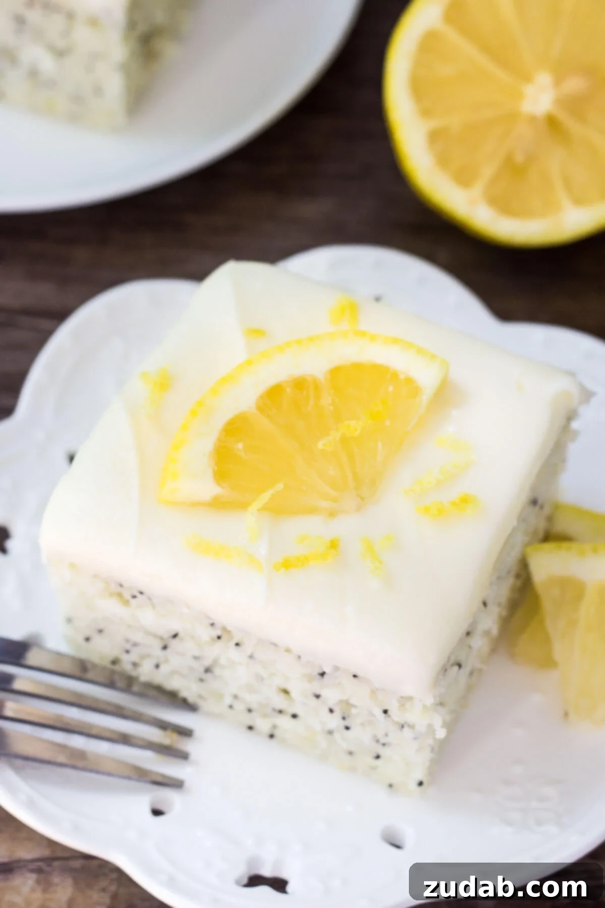 This Lemon Poppy Seed Cake with Cream Cheese Frosting is soft, moist & deliciously buttery with a fresh lemon flavor. Dotted with poppy seeds & topped with cream cheese frosting - it's the perfect dessert for lemon lovers!