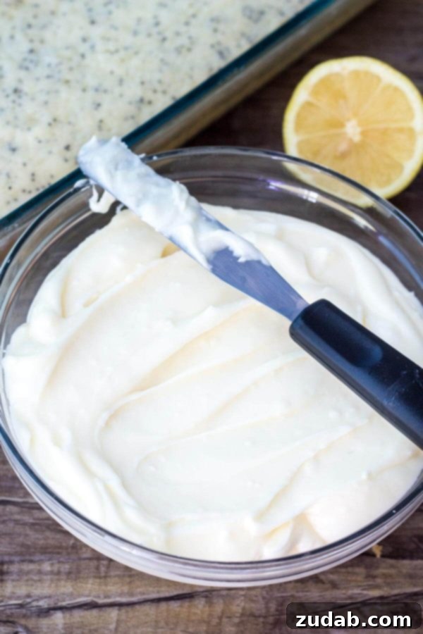 This Lemon Poppy Seed Cake with Cream Cheese Frosting is soft, moist & deliciously buttery with a fresh lemon flavor. Dotted with poppy seeds & topped with cream cheese frosting - it's the perfect dessert for lemon lovers!