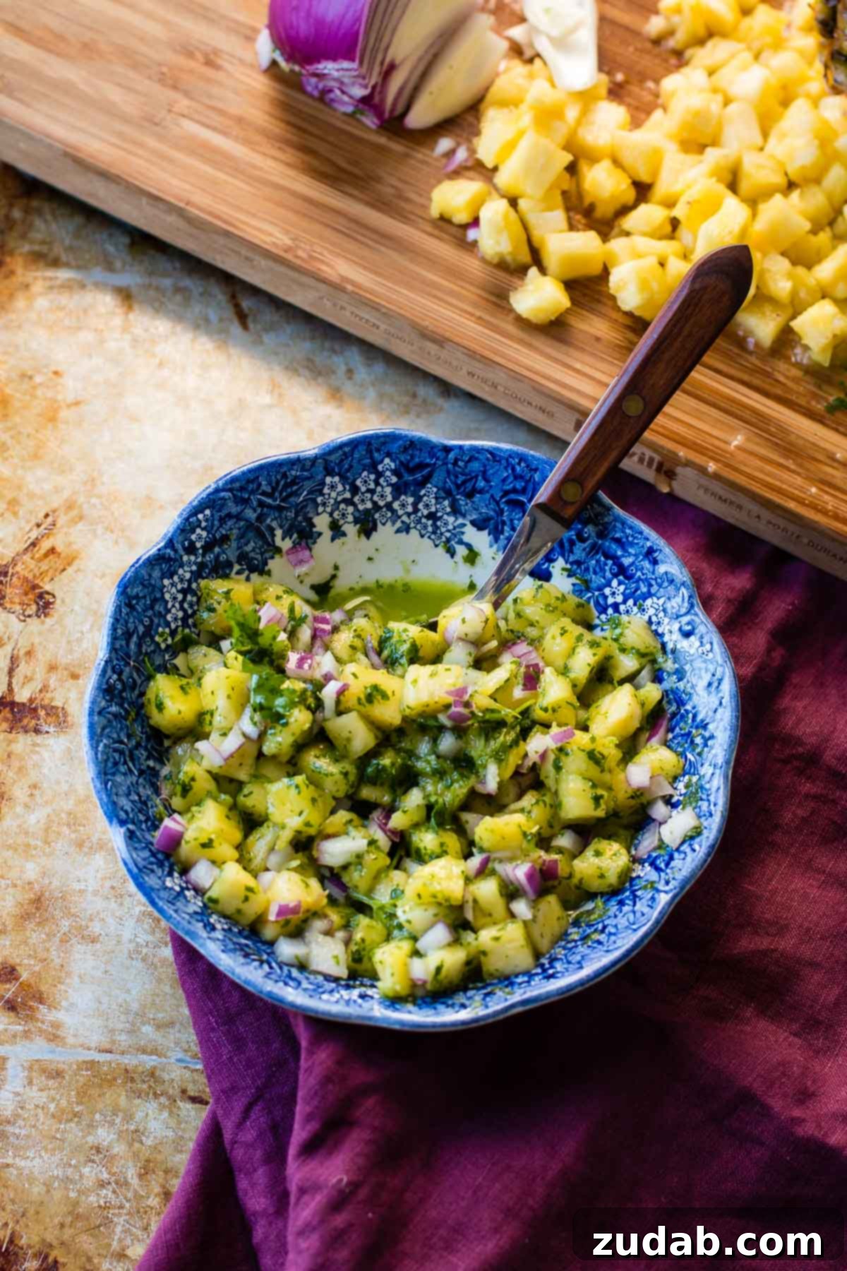 Ripe Pineapple and Cilantro for Chimichurri Fresh, juicy pineapple chunks alongside vibrant cilantro, ready to be blended into a delicious chimichurri sauce.