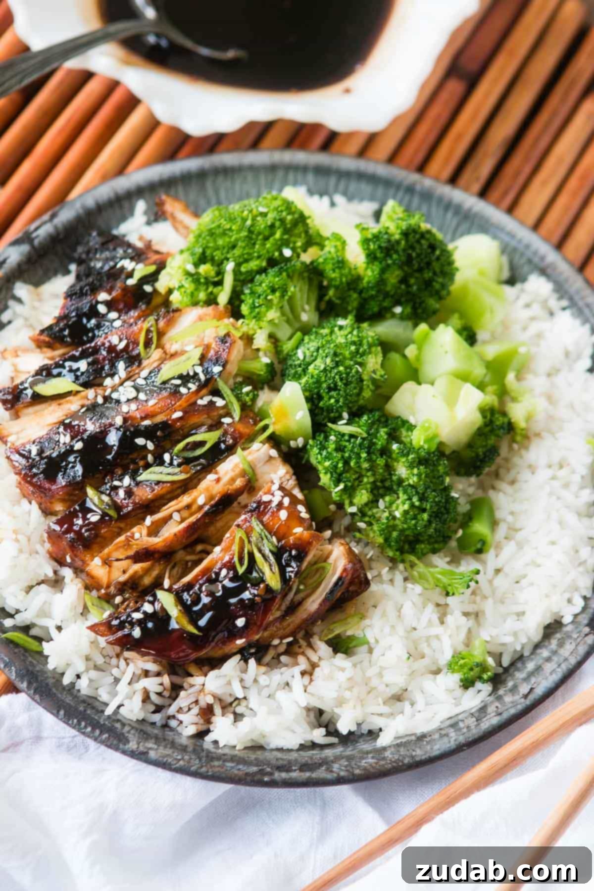 Close-up of golden brown Sticky Asian Grilled Chicken Breasts, glistening with flavorful sauce.
