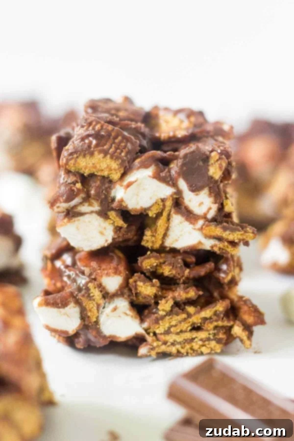 Indulge in these easy no-bake s'mores bars! A perfect summer dessert made with 4 ingredients (Hershey's chocolate, mini marshmallows, Golden Grahams) in under 15 minutes. Learn how to make no bake s'mores bars at home! This simple recipe calls for 4 ingredients and takes under 15 minutes to come together. This summer dessert recipe is so yummy and easy you'll want to make it every week. Hershey's chocolate, mini marshmallows, Golden Grahams
