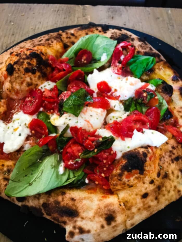 Your Blueprint for a European Adventure 9 A delicious Capri Pizza from the bustling Mercato Centrale in Florence, Italy, showcasing the fresh, local ingredients of Tuscan cuisine. ohsweetbasil.com