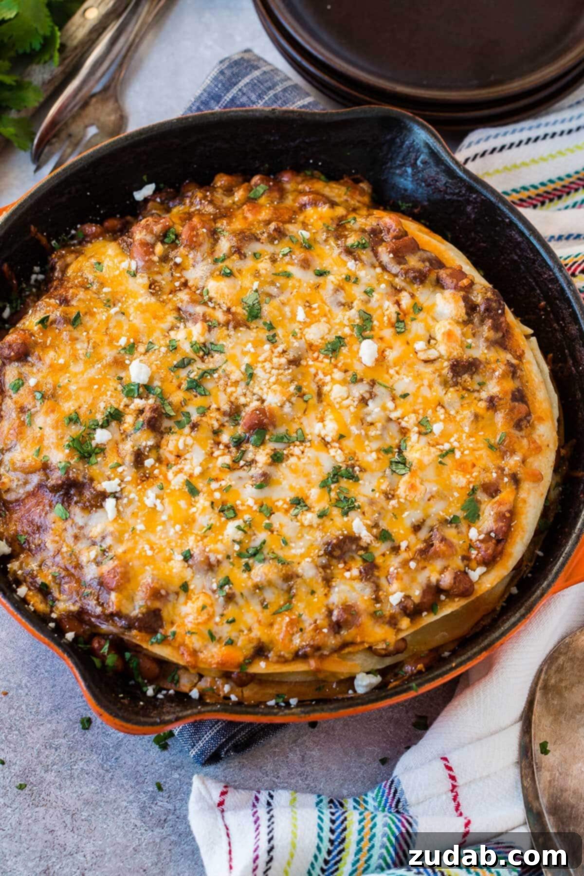 One Pan Cheesy Beef Enchilada Bake 6 a photo taken over the top of ground beef enchilada casserole in a cast iron skillet