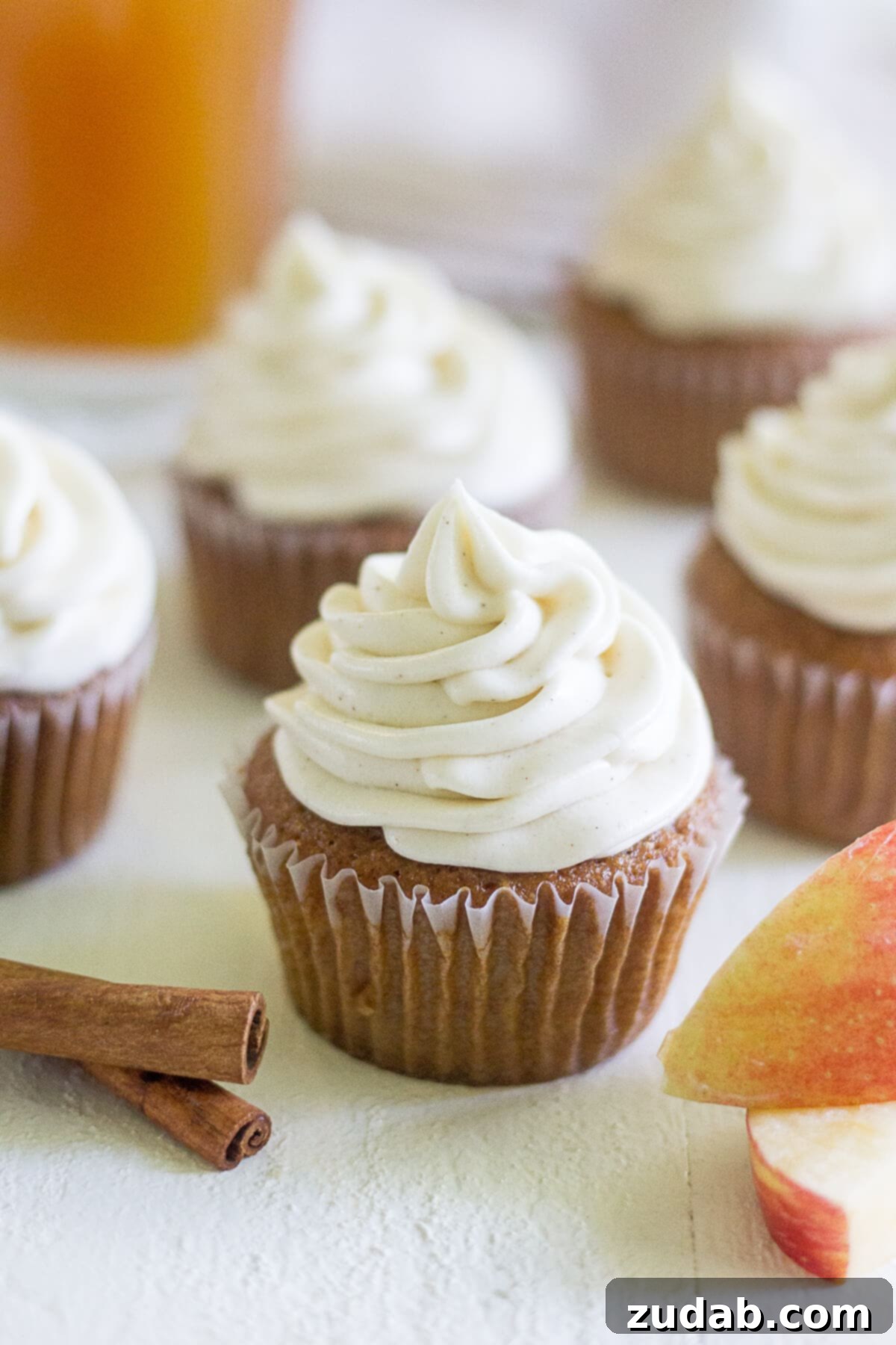 Warm Apple Cider Cupcakes with Spiced Cream Cheese Frosting 2 five apple cider cupcakes frosted with a swirl of cream cheese frosting