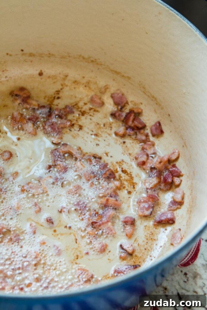 Easy One Pot Cauliflower Chowder 11 cooking bacon in a dutch oven ohsweetbasil.com