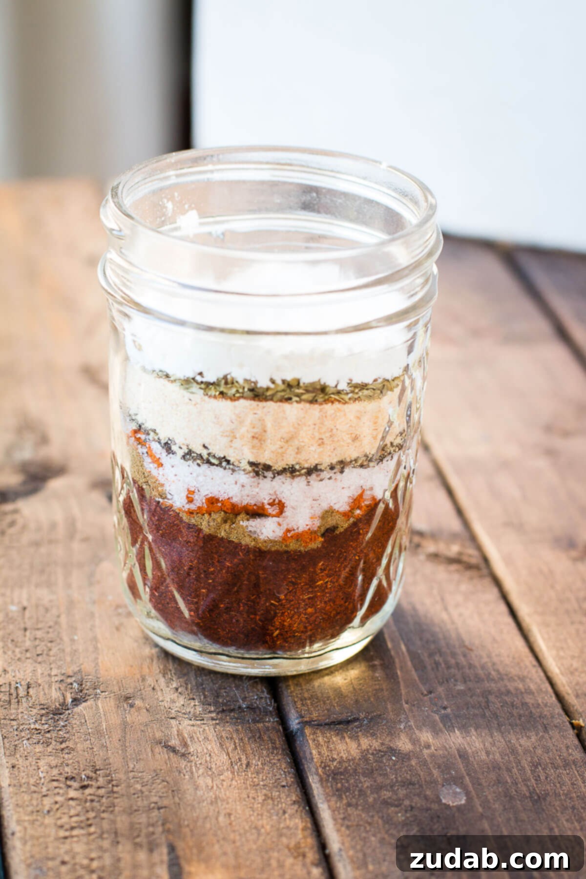 Craft Your Own Taco Spice 2 A jar of homemade taco seasoning in a spice cupboard, showcasing its fresh, vibrant spices.