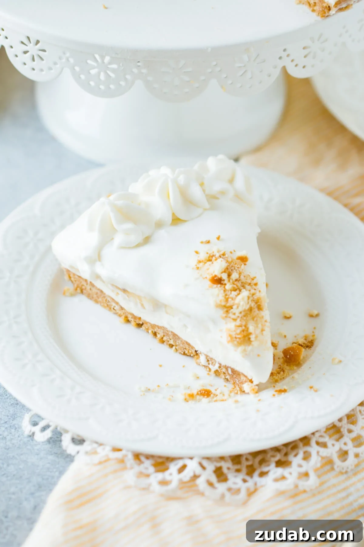 Dreamy No-Bake Banana Pudding Cheesecake 2 slice of no bake banana pudding cheesecake on white plate