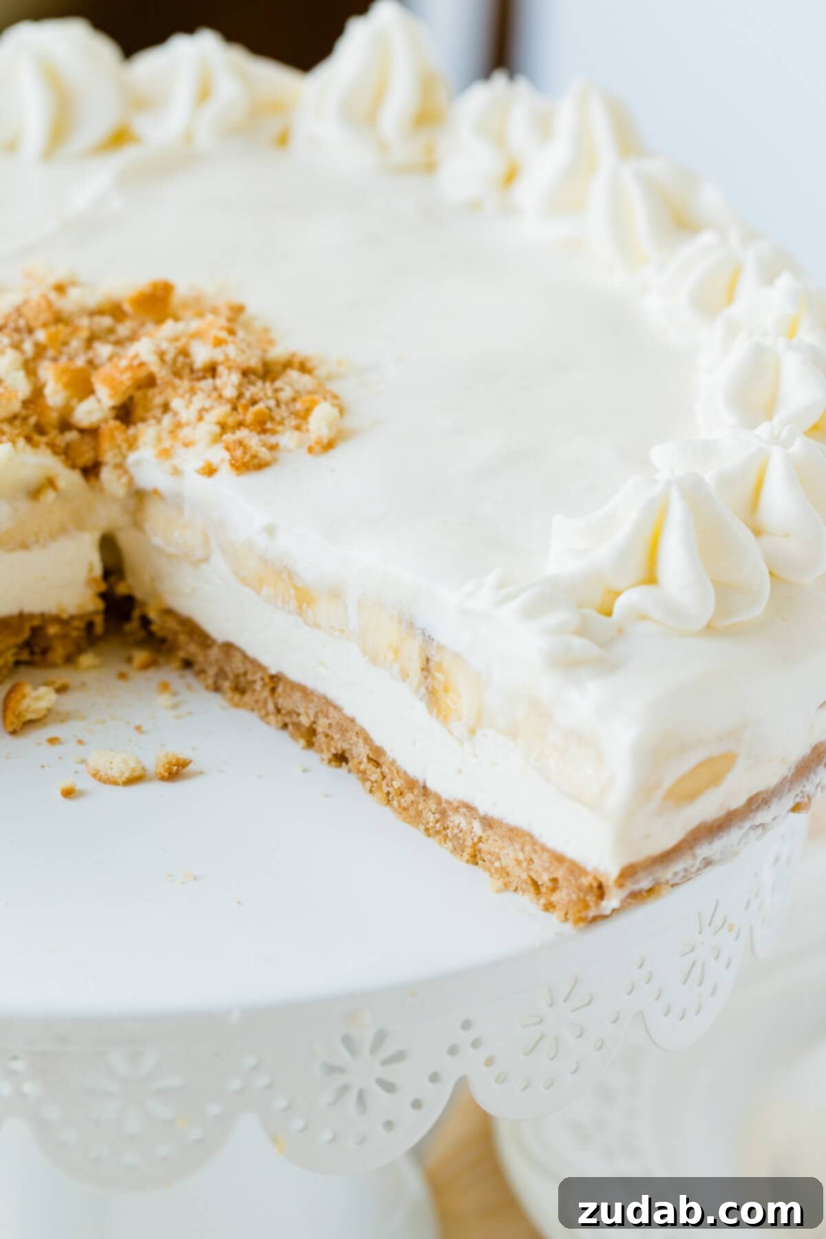 Dreamy No-Bake Banana Pudding Cheesecake 4 banana cheesecake on white cake stand