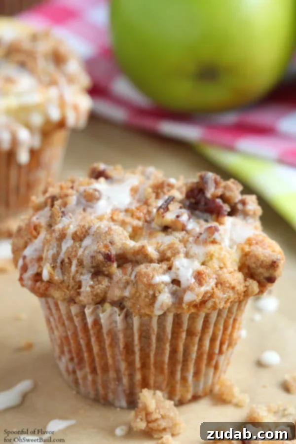 Sweet Strawberry Muffins 7 Fluffy apple coffee cake muffins topped with streusel, on a baking rack.