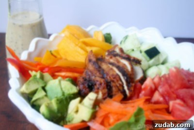 Tropical Teriyaki Chicken Salad with Sesame Ginger Dressing 3 Close-up of Teriyaki Chicken Salad ingredients, showing sliced chicken, cucumbers, and mango