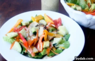 Tropical Teriyaki Chicken Salad with Sesame Ginger Dressing 4 A bowl of fresh ingredients for Teriyaki Chicken Salad, including chopped vegetables and mango