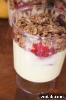 Thoughtful Ways to Celebrate Mom 4 Colorful Orange Cream Fruit and Yogurt Parfait in a tall glass, garnished with mint