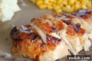 Thoughtful Ways to Celebrate Mom 9 Crispy golden Honey Roasted Chicken on a platter, garnished with fresh herbs