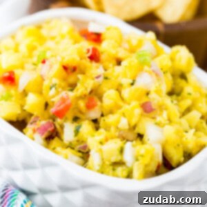 A small white dish displaying a portion of the fresh pineapple salsa, perfect for serving.