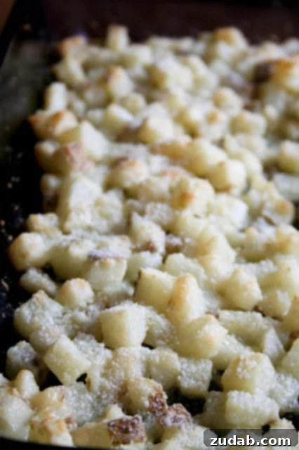 Potatoes tossed with butter and cheese in a large plastic bag for even coating