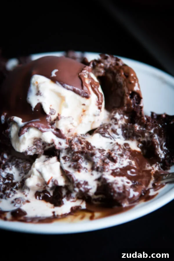 Perfect Copycat Chili's Molten Lava Cakes 2 Two decadent homemade molten lava cakes, rich chocolate oozing from the center, topped with vanilla ice cream and magic chocolate shell, a perfect Chili's copycat dessert.