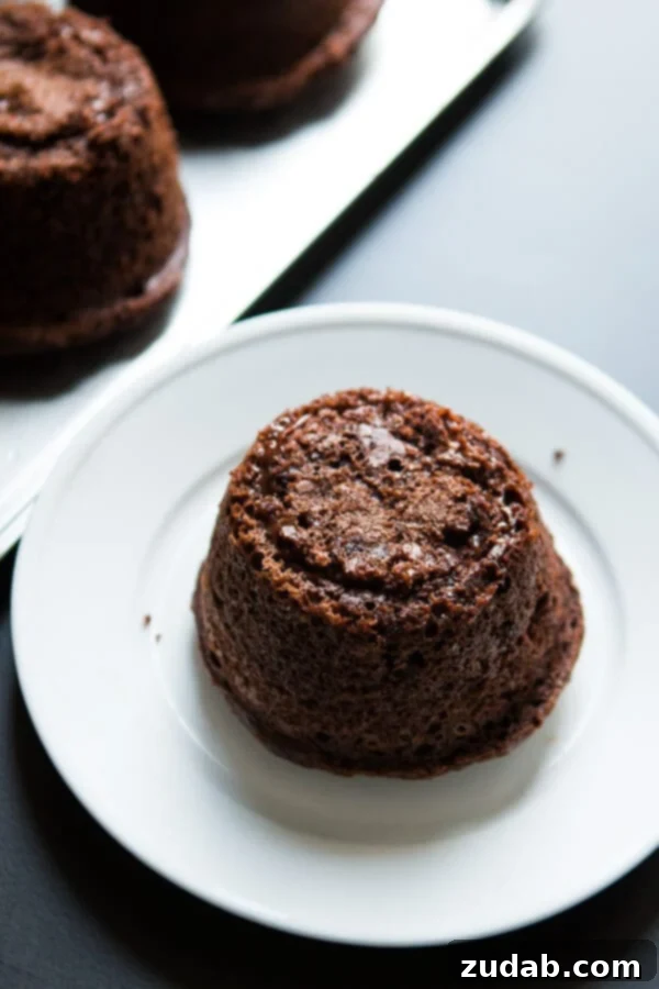 Copycat Chili's molten lava cakes recipe is way easier to make than you probably think and that hot fudge oozing out is such a crowd pleaser! A molten lava cake with a visible, warm, gooey chocolate center, perfectly reheated and ready for toppings.