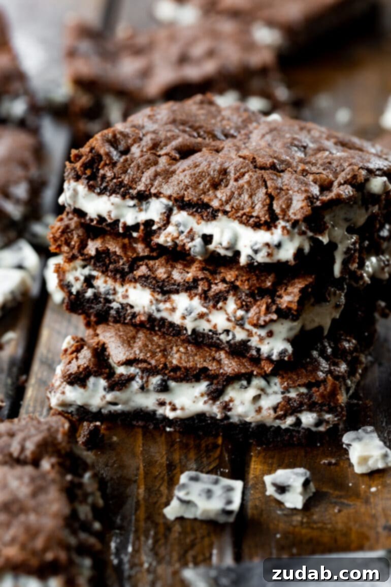 Ultimate Cookies and Cream Brownies 4 A beautiful shot of three cookies and cream brownies, stacked to reveal their gooey layers, ready to be enjoyed.