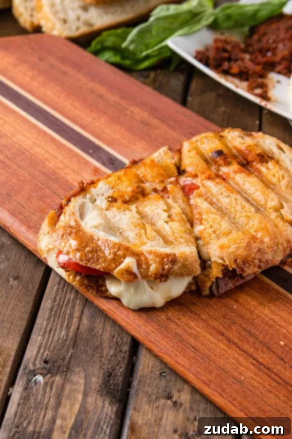 Ready to press Sun-Dried Tomato Pesto Panini Assembled Sun-Dried Tomato Pesto Panini before pressing, showing layers of ingredients
