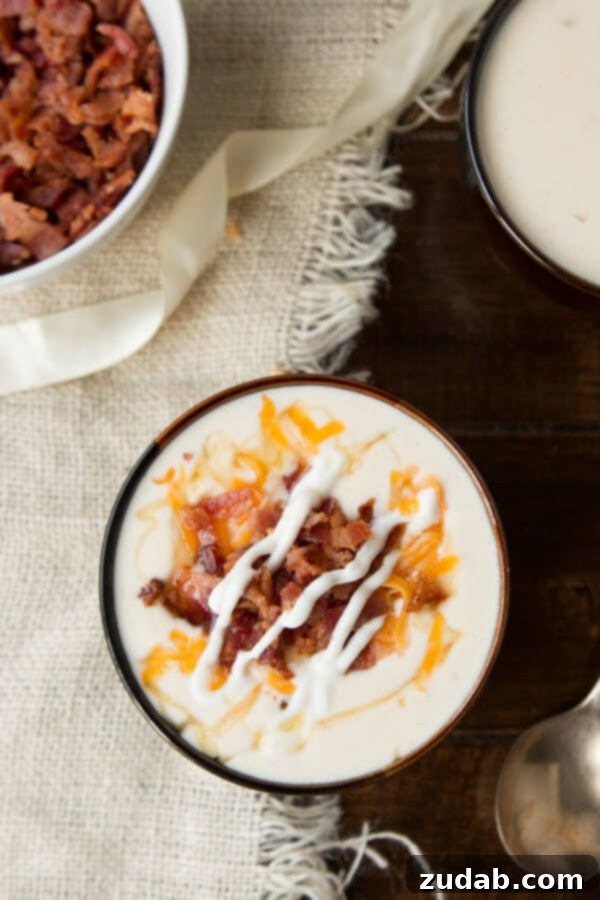 Golden Loaded Baked Potato Soup with the Secret Honey Drizzle The ultimate Golden Loaded Baked Potato Soup, perfectly garnished with bacon, cheese, and a hint of honey. A perfect meal from ohsweetbasil.com.