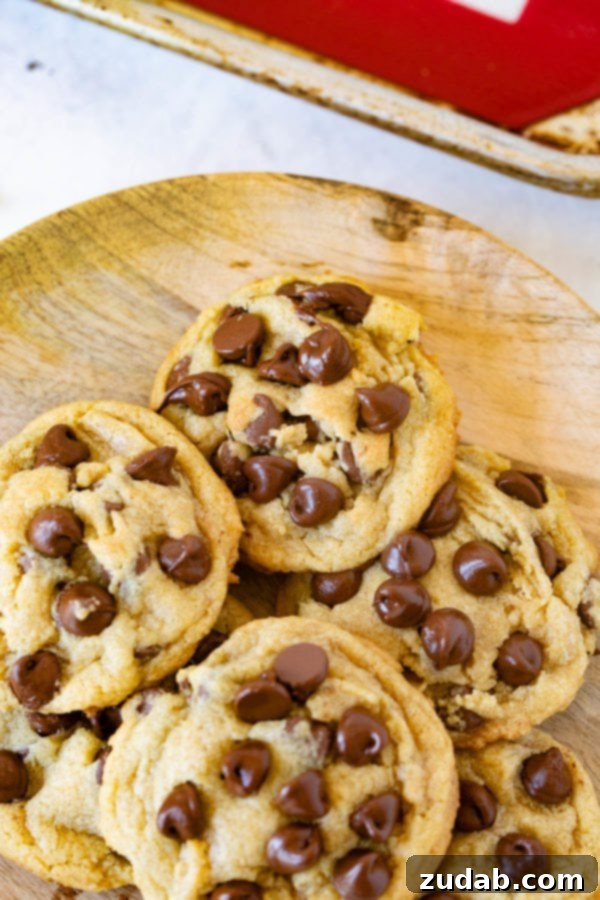 Plate of Chocolate Chip Pudding Cookies A charming wooden plate overflowing with perfectly baked chocolate chip pudding cookies, ready for sharing.