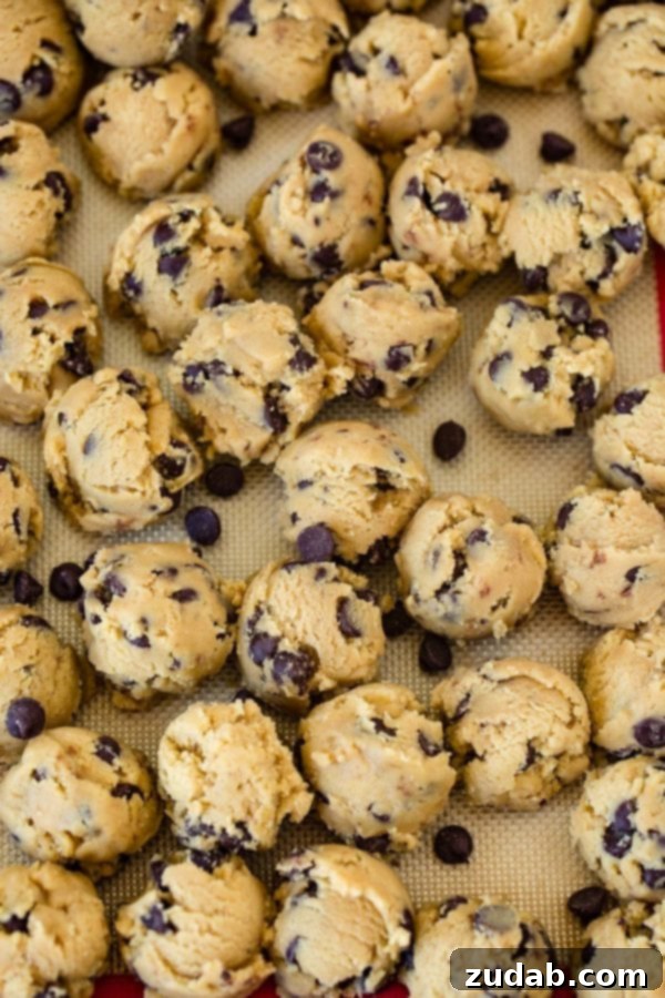 Homemade Chocolate Chip Cookie Dough A sheet pan dotted with neatly scooped balls of homemade chocolate chip cookie dough, ready to be baked into golden perfection.